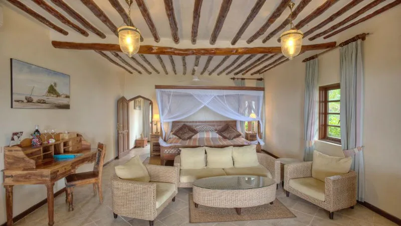 A beautifully decorated guest room with an ocean view.