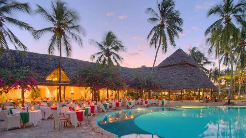 The beachfront restaurant with a romantic dinner setup.