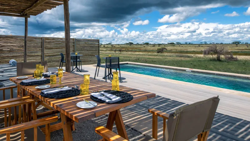 The interior of a luxurious tented suite with views of the plains.